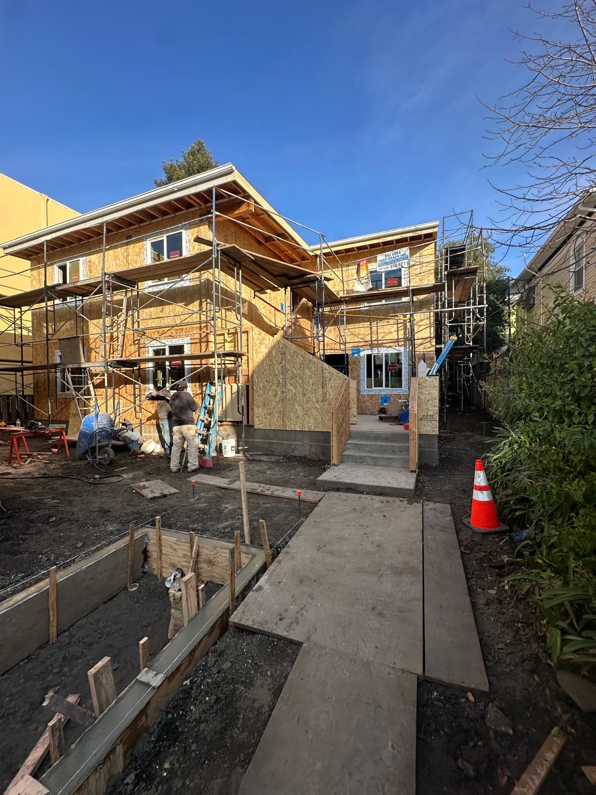 Two-story Bay Area building under construction with scaffolding