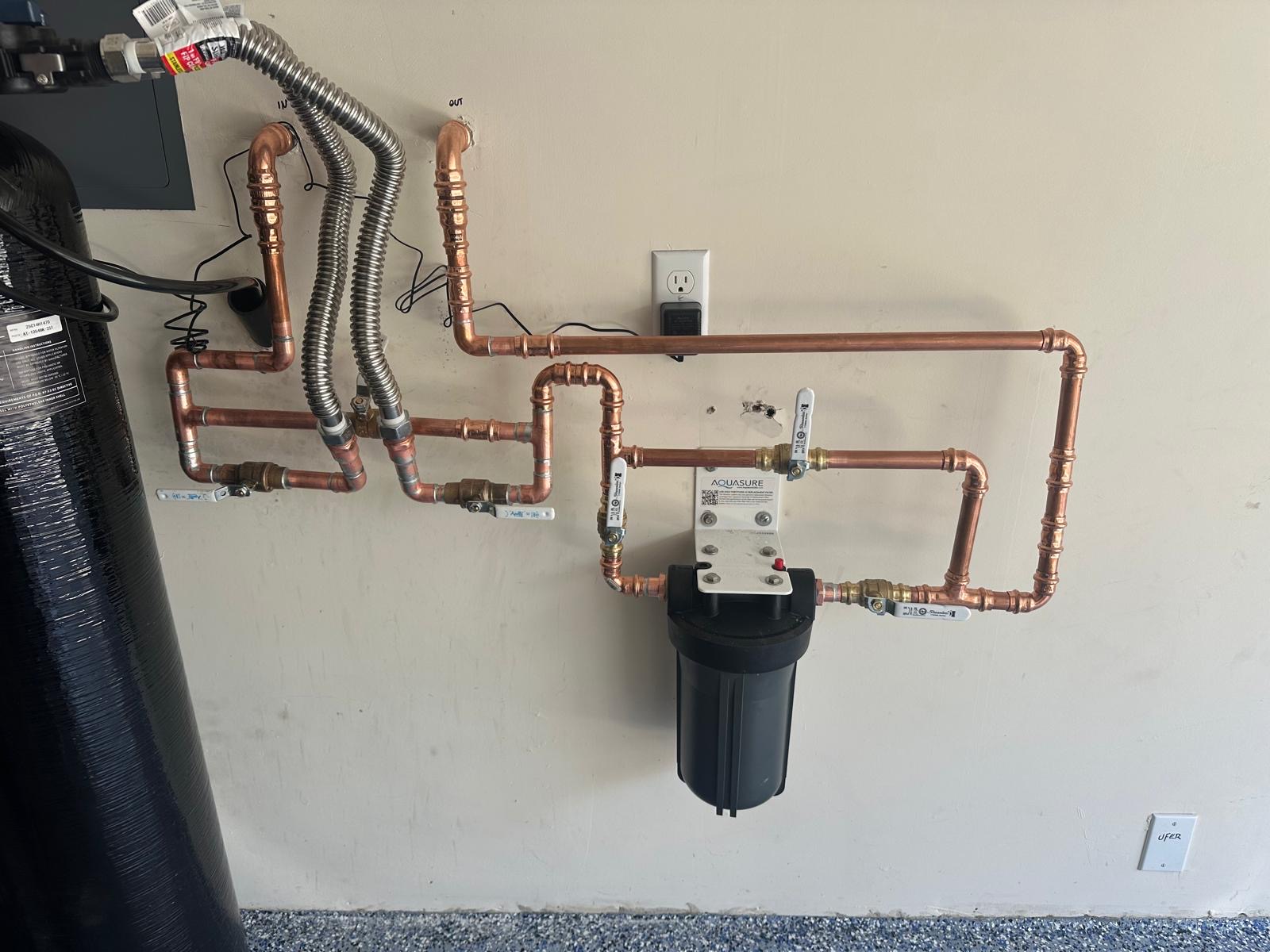 Copper manifold with valves connecting a water softener and whole-house filter