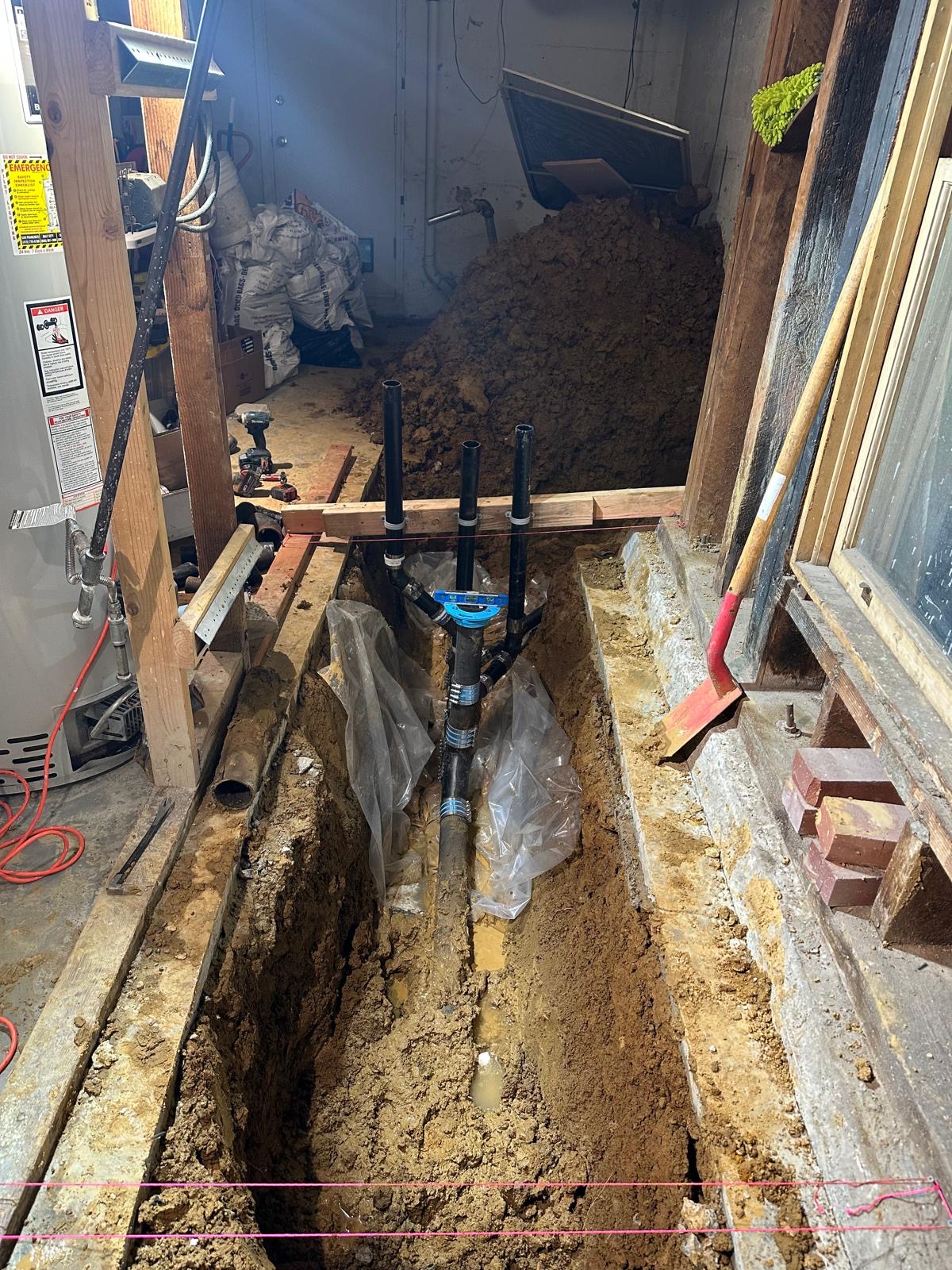 New underground drain and sewer piping installed in an open trench
