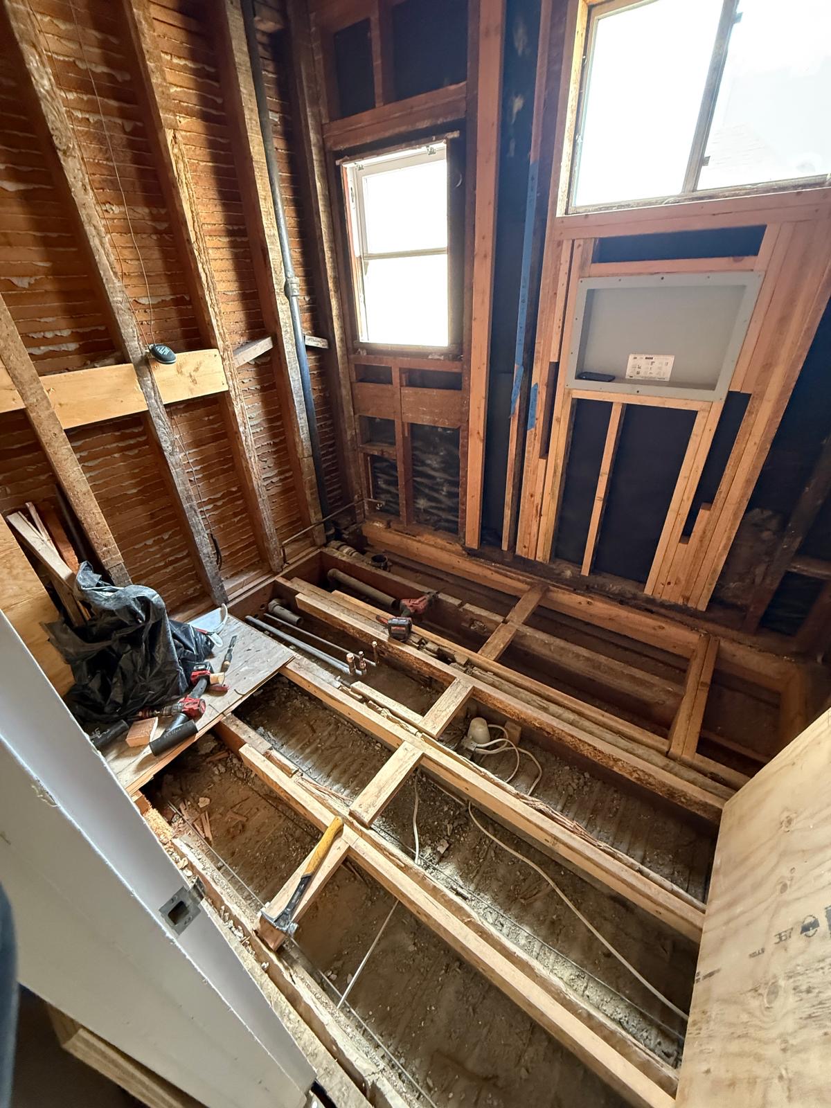 Bathroom stripped to the framing with new supply and drain lines