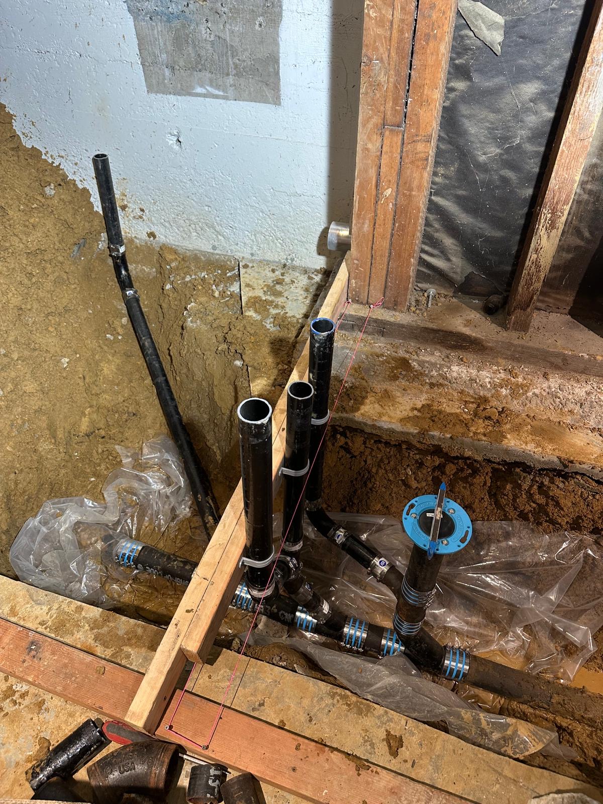 Cast iron drain branches and closet flange set below the floor